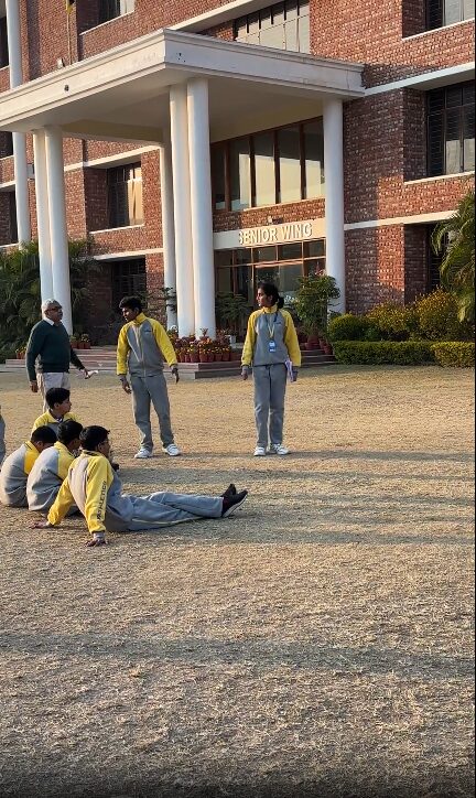 Outdoor dramatization in progress on the school grounds.