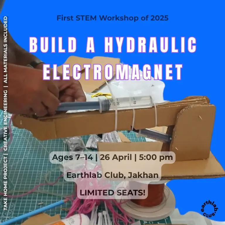 Children building and operating a DIY hydraulic electromagnet using syringes, wires, and magnets at a STEM workshop in Dehradun, guided by a science expert